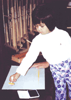 A child composes music with a rubber stamp