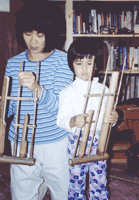 Mother and child playing Asian musical instruments